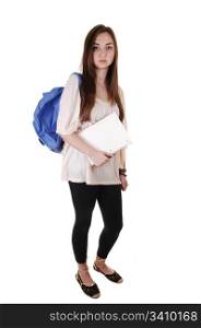 A pretty teenager in black tights and a blue backpack over hershoulder standing in the studio for white background.
