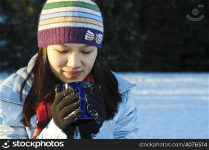 A pretty woman drinking a cup of coffee outdoor