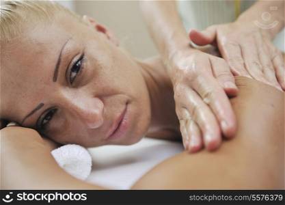A pretty woman getting a shoulder and back massage at spa and wellness center