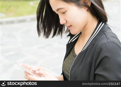 A pretty woman playing the smart phone