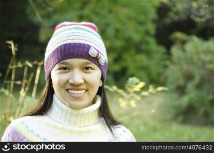 A pretty woman smiling in an outdoor setting