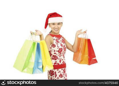 A pretty woman wearing santa hat carrying shopping bags