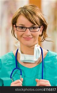 A pretty young female doctor in scrubs with a stethoscope