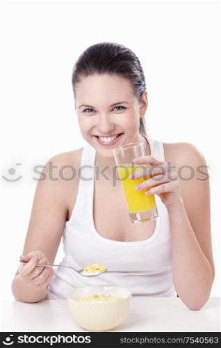 A pretty young girl at breakfast on a white background