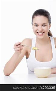 A pretty young girl has corn flakes on a white background
