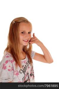 A pretty young girl with blond hair standing in profile for white background pretending to make a phone call.