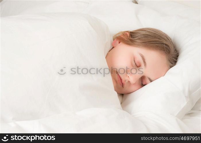 a pretty young woman asleep in bed