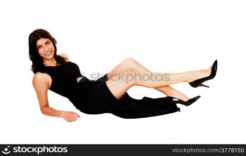 A pretty young woman in a long black dress lying on the floor, smiling,isolated for white background.