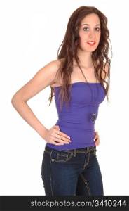 A pretty young woman in jeans, with a strapless top and long hair standing in the studio for white background.
