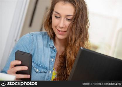 a pretty young woman with long hairs using smartphone