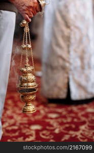 A priest in the Orthodox Christian Church holds in his hands the censer.. A priest in the Orthodox Christian Church holds in his hands the censer