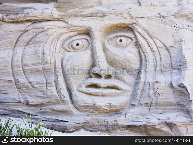 A primeval face appears in the cliffs on Waldron Island in the San Juan Islands of Washington State. This sand sculpture is carved into the side of a sandy cliff.