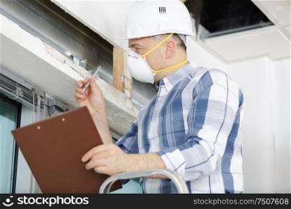 a professional construction worker is wearing a mask