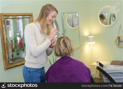 a professional hairdresser doing hair-colouring