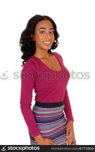 A profile image of a african american women in a burgundy top an a colorfulskirt standing, isolated for white background.
