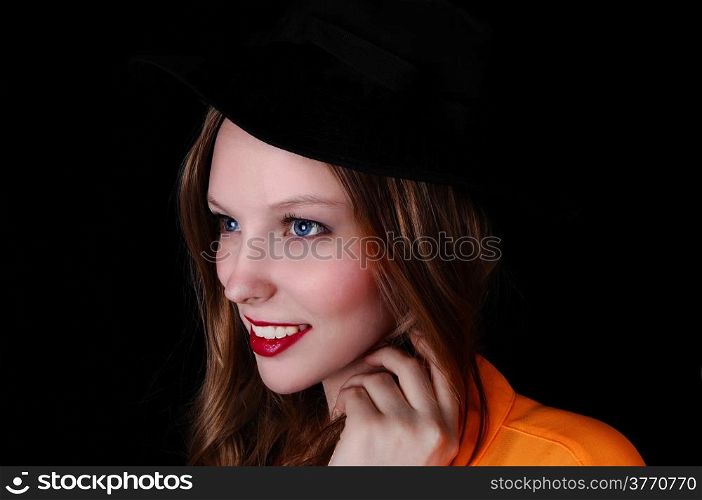 A profile portrait picture of a teenage girl wearing a black hat, isolated for black background.