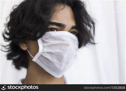 A protected teenager wearing a mask