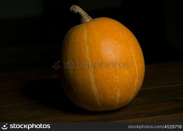 A Pumpkin in the dark background, studio picture