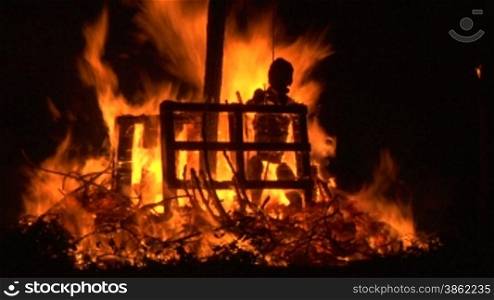 A puppet of an old witch is burnt on a bonfire