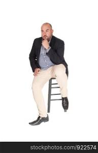 A puzzled middle age business man sitting on a chair with his hand on his chin, looking for a solution for his problem, isolated for whitebackground