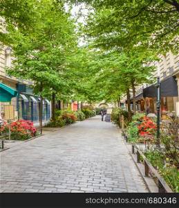 A quiet street with restaurants in the bohemian Marais district of Paris.. A quiet street with restaurants in the bohemian Marais district of Paris