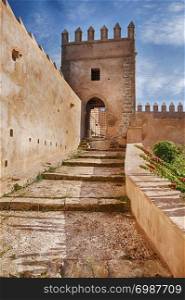 A ramp with steps leads upwards towards one of the guard towers that are located on the outside walls of the Kasbah in Rabat, Morocco.