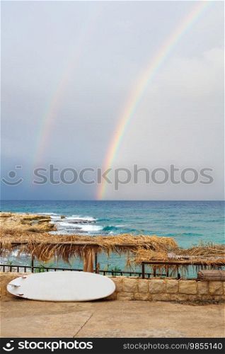 A rare, natural phenomenon that gives positivity to everyone. The rainbow is the basis of all colors and children’s magic. Tropical resort. Summer vibe.. Beautiful rainbow on the tropical resort