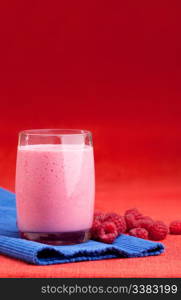 A raspberry smoothie on a red and blue background