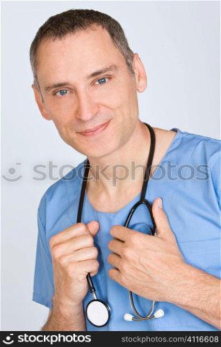 A reassuringly friendly male doctor in scrubs with a stethoscope