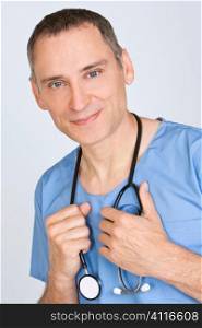 A reassuringly friendly male doctor in scrubs with a stethoscope