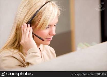 A receptionist talking on the phone with a headset