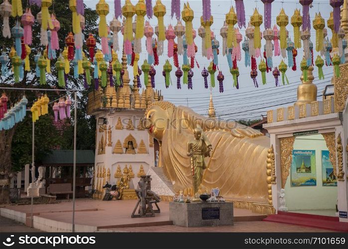 a reclining Buddha at Wat Pong Sunan Temple at dusk the city of Phrae in the north of Thailand. Thailand, Phrae November, 2018.. THAILAND PHRAE WAT PONG SUNAN TEMPLE