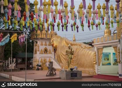 a reclining Buddha at Wat Pong Sunan Temple at dusk the city of Phrae in the north of Thailand. Thailand, Phrae November, 2018.. THAILAND PHRAE WAT PONG SUNAN TEMPLE