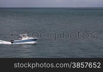 A recreational boat enters and exits the frame