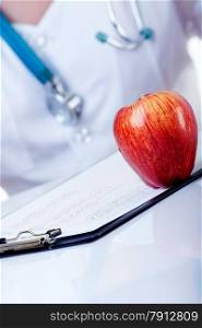 A Red Apple Lying on the Doctor&rsquo;s Table