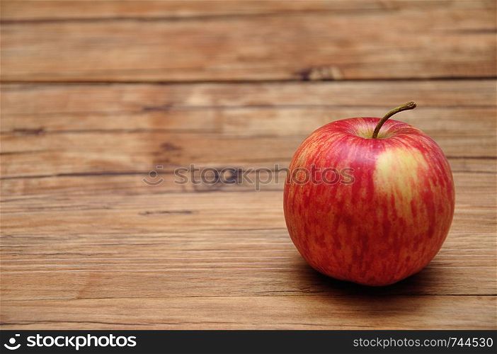 A red apple on a wooden background