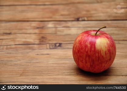 A red apple on a wooden background