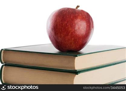A red apple on top of books on a white background