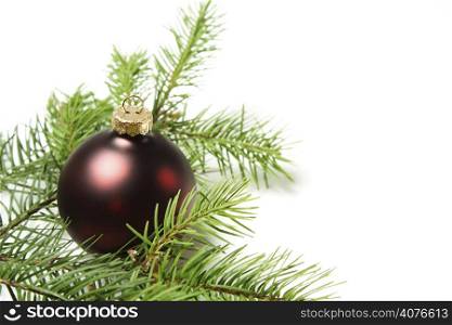 A red christmas ornament with christmas tree