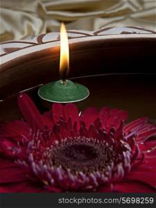 A red flower and a candle