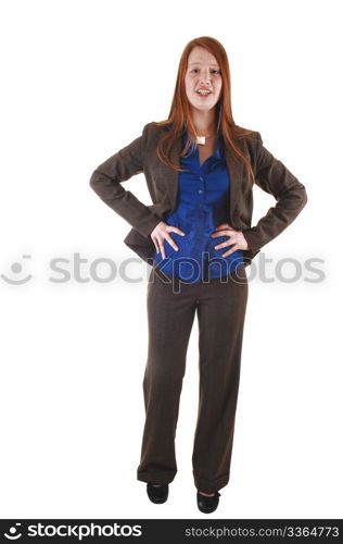 A red haired young businesswoman standing in the studio in a brownsuit and blue blouse, for white background.
