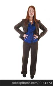 A red haired young businesswoman standing in the studio in a brownsuit and blue blouse, for white background.