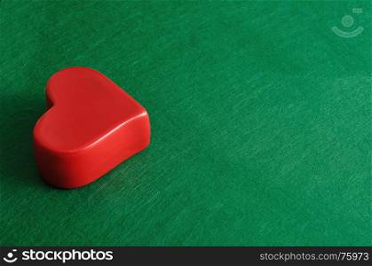 A red heart isolated on a green background