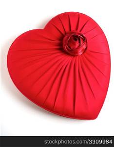 A red, heart-shaped box with an imitation rose on it, ideal for a gift to a loved one, over white with a light shadow