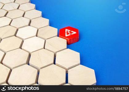 A red hexagon with a attention sign attaches to an array of other shapes. Invasion, inconsistency. Lack of space. Violation of integrity, threat to system security. Suspicious situation. Virus.