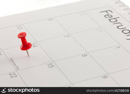 A red pin in Valentines Day on a calendar