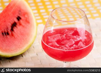 A red watermelon drink on a picnic table