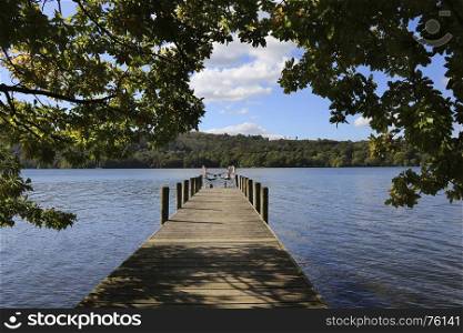 A relaxing spot on a jetty by Lake Windermere in the Lake District in Cumbria in the northwest of England in the United Kingdom. Windermere is the largest natural lake in England and is within the Lake District National Park.