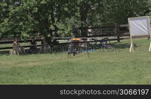 A remote controlled flying craft. Helicopter for aerial photo and video is flying and landing.