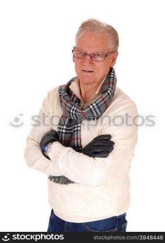 A retired senior man standing waist up in a sweater, scarf and leathergloves, isolated for white background.